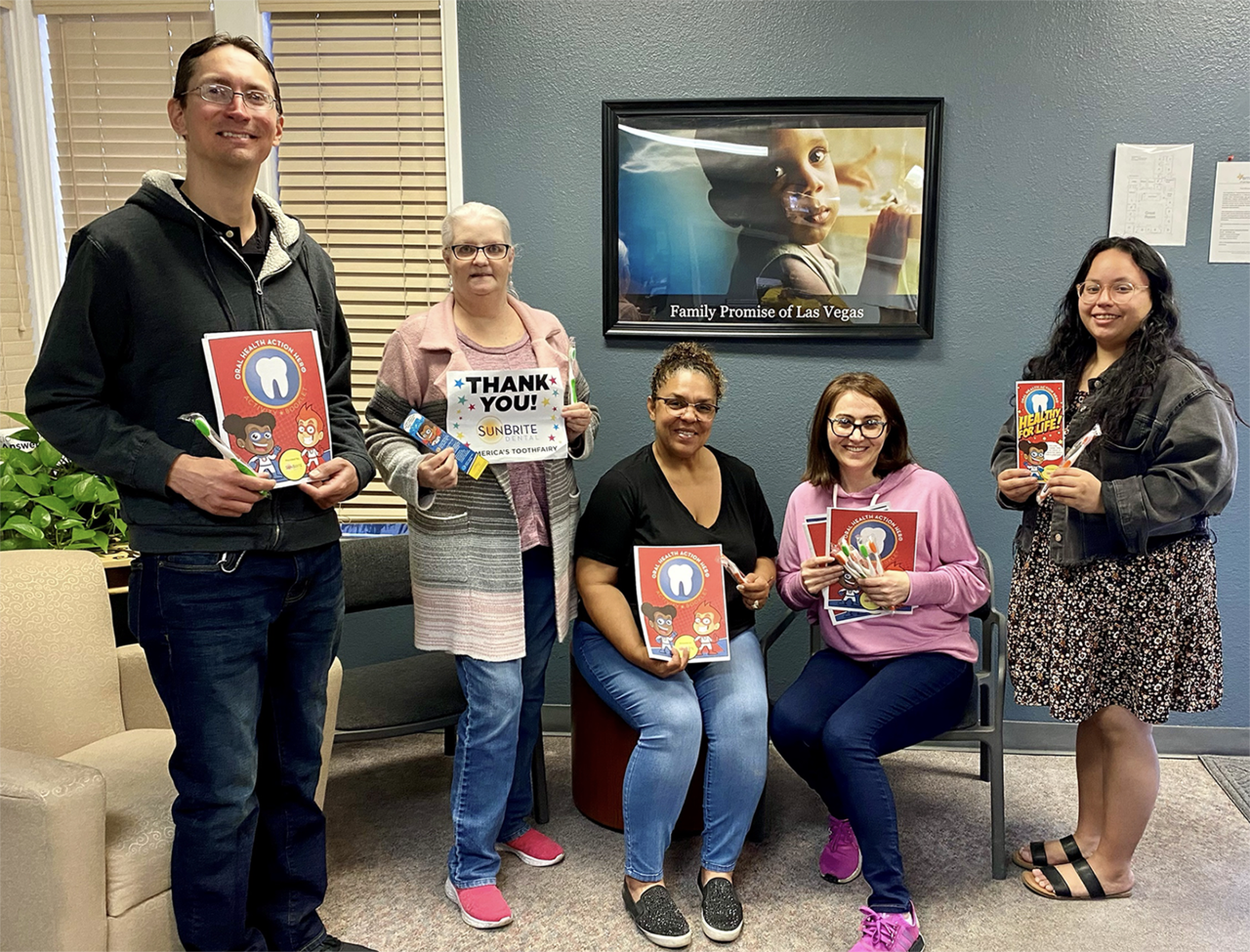 Family Promise of Las Vegas provides displaced families the opportunity to achieve housing stability by providing short term transitional shelter, case management and essential needs. Here their staff members hold oral health education resources and hygiene supplies. The education kits were sponsored by SunBrite Dental, a dental care provider located in Las Vegas that participates in the Smile Guardian Program. | Image Credit: America’s ToothFairy.