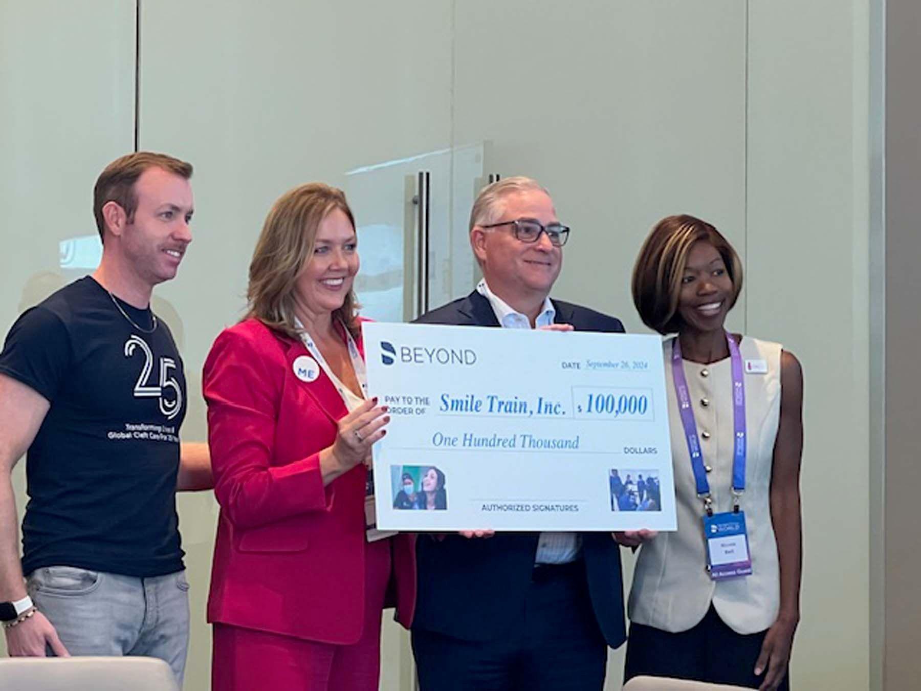 Dentsply Sirona presents a $100,000 check to SmileTrain. | Image Credit: © Stan Goff